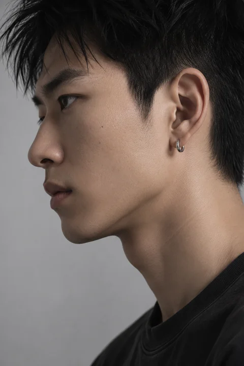 KAI in side profile, with the complete nose, chin and silver earring visible