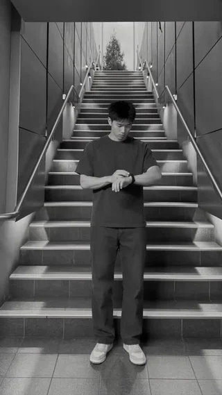 Kai’s outfit film on a monochrome staircase