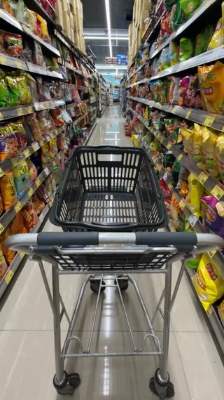A shopping-cart point of view moving through a snack aisle